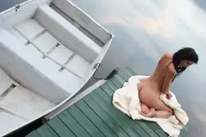 Nude Girl Sitting On Dock